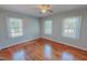 Bright bedroom showcasing hardwood floors, neutral walls, and multiple windows for ample natural light at 171 Magnolia Dr, Roxboro, NC 27573
