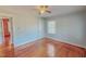 Cozy bedroom with hardwood floors, a ceiling fan, and a connecting door to another room, maximizing space at 171 Magnolia Dr, Roxboro, NC 27573