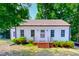 Charming home with white painted siding, covered front porch, and manicured shrubs at 171 Magnolia Dr, Roxboro, NC 27573