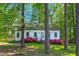 Quaint home with blooming bushes, mature trees, and a manicured lawn at 171 Magnolia Dr, Roxboro, NC 27573