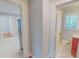 Hallway showcasing access to the kitchen and bathroom with marble-style floors and neutral-colored walls at 171 Magnolia Dr, Roxboro, NC 27573