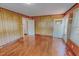 Spacious living room with wood-paneled walls, hardwood floors, and natural light at 171 Magnolia Dr, Roxboro, NC 27573