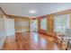 Bright living room featuring wood-paneled walls, hardwood floors, and natural light from the windows at 171 Magnolia Dr, Roxboro, NC 27573