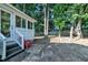 Charming screened in porch with steps into the lush, tree-lined backyard and mature landscaping at 1905 Indianwood Ct, Raleigh, NC 27604