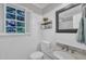 Bright bathroom featuring beadboard walls, a marble countertop, and a window with natural light at 1905 Indianwood Ct, Raleigh, NC 27604