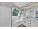 Bright bathroom featuring a glass enclosed shower, soaker tub, and large window at 1905 Indianwood Ct, Raleigh, NC 27604