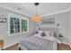 Cozy bedroom with natural light from large windows, designer lighting, and stylish decor at 1905 Indianwood Ct, Raleigh, NC 27604