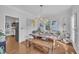 Bright dining room featuring a wooden table, modern chandelier, and wainscoting, perfect for entertaining at 1905 Indianwood Ct, Raleigh, NC 27604