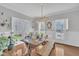Charming dining room with natural light, a farmhouse-style table, and stylish decor at 1905 Indianwood Ct, Raleigh, NC 27604