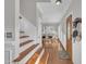 Welcoming entryway with hardwood floors, stairs, and an open view to the dining area, creating a warm and inviting atmosphere at 1905 Indianwood Ct, Raleigh, NC 27604