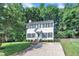 Traditional two-story home with a neatly landscaped yard, featuring classic architecture and symmetrical window placement at 1905 Indianwood Ct, Raleigh, NC 27604