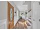 Inviting foyer with hardwood floors, a staircase, and natural light creates a warm and welcoming ambiance at 1905 Indianwood Ct, Raleigh, NC 27604