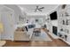 Bright living room featuring hardwood floors, a cozy seating area with a sofa, and a fireplace with a built-in bookcase at 1905 Indianwood Ct, Raleigh, NC 27604