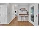Open-concept sitting area with bar seating featuring hardwood floors and access to outdoor patio at 1905 Indianwood Ct, Raleigh, NC 27604