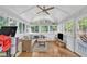 Bright sunroom with vaulted ceiling, large windows, comfortable seating, and natural light at 1905 Indianwood Ct, Raleigh, NC 27604