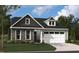 Charming home featuring stone accents, gray shingles, light blue siding, a 2-car garage and well-manicured lawn at 2004 Kapalua Way # 189, Durham, NC 27703