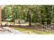 Fenced backyard with mature trees and space for outdoor seating and activities at 2005 Cole Mill Rd, Durham, NC 27712