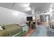 Open basement area featuring a bed, TV setup, and versatile layout for living and entertainment at 2005 Cole Mill Rd, Durham, NC 27712
