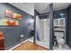Cozy bathroom with shower, toilet, cabinet, and sink, accented with modern art and textures at 2005 Cole Mill Rd, Durham, NC 27712