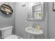 Bathroom features a pedestal sink, toilet, and mirror at 2005 Cole Mill Rd, Durham, NC 27712