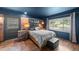 Bedroom features exposed brick wall, hardwood floors, and a modern aesthetic at 2005 Cole Mill Rd, Durham, NC 27712