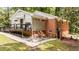 Back exterior of the home featuring a deck, stairs, and brick facade at 2005 Cole Mill Rd, Durham, NC 27712