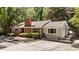 Attractive single-story home with brick facade, large windows, well-kept shrubbery, and black iron gate at 2005 Cole Mill Rd, Durham, NC 27712