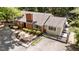 An elevated view of a brick home with attractive landscaping and walkway with black iron gate at 2005 Cole Mill Rd, Durham, NC 27712