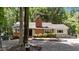Single story brick home featuring mature trees, well-maintained landscaping, and a welcoming front entrance at 2005 Cole Mill Rd, Durham, NC 27712