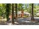 Charming brick home featuring mature trees, well-maintained landscaping, and a welcoming front entrance at 2005 Cole Mill Rd, Durham, NC 27712