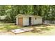 Detached garage in the backyard with a wooden door and a fenced-in area at 2005 Cole Mill Rd, Durham, NC 27712