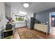 Bright kitchen featuring modern stainless steel appliances, white cabinets, and a large window at 2005 Cole Mill Rd, Durham, NC 27712