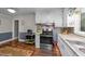 Charming kitchen features stainless steel appliances, granite countertops, and wooden floors at 2005 Cole Mill Rd, Durham, NC 27712