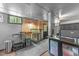 Rustic kitchenette featuring stainless steel fixtures, brick accent wall, and modern appliances at 2005 Cole Mill Rd, Durham, NC 27712