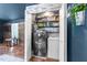 Efficient laundry room with modern washer and dryer, neatly organized storage shelves, and stylish decor at 2005 Cole Mill Rd, Durham, NC 27712