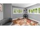 Cozy living room with hardwood floors and bright windows overlooking backyard at 2005 Cole Mill Rd, Durham, NC 27712