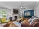Charming living room with brick fireplace, wood floors, comfortable seating, and ample natural light at 2005 Cole Mill Rd, Durham, NC 27712