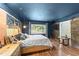 Bright main bedroom offering exposed brick, wooden floors, and a large window overlooking the neighborhood at 2005 Cole Mill Rd, Durham, NC 27712