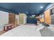 Well-lit bedroom featuring a sliding barn door and access to a kitchen, complemented by brick and blue accent walls at 2005 Cole Mill Rd, Durham, NC 27712