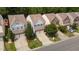 Aerial view of a neighborhood street with well-maintained houses and tree-lined streets at 2057 Tanners Mill Dr, Durham, NC 27703