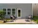 Outdoor patio with furniture, surrounded by grass and the exterior of the home at 2057 Tanners Mill Dr, Durham, NC 27703