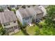 Aerial view of a fenced backyard with a patio, seating, and a well-manicured lawn at 2057 Tanners Mill Dr, Durham, NC 27703