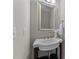 Charming powder room features a pedestal sink, elegant faucet, and decorative mirror at 2057 Tanners Mill Dr, Durham, NC 27703