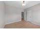 Bedroom featuring light wood floors, overhead lighting, and a double door closet at 2057 Tanners Mill Dr, Durham, NC 27703
