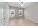 Empty bedroom featuring light wood floors and two windows with views to the exterior at 2057 Tanners Mill Dr, Durham, NC 27703