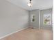 Bedroom featuring light wood floors, overhead lighting, and a view to the exterior at 2057 Tanners Mill Dr, Durham, NC 27703