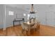 Dining room featuring hardwood floors, a modern chandelier, and neutral decor at 2057 Tanners Mill Dr, Durham, NC 27703