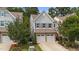 Two-story home featuring a stone facade, a two-car garage, and well-maintained landscaping at 2057 Tanners Mill Dr, Durham, NC 27703