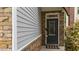 Close-up of the front door featuring stone accents and a 'welcome' mat at 2057 Tanners Mill Dr, Durham, NC 27703
