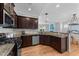 Open kitchen with stainless steel appliances, granite countertops, and view into the living space at 2057 Tanners Mill Dr, Durham, NC 27703